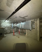 Commercial parkade exhaust fan and galvanized ductwork installed in an underground parking garage